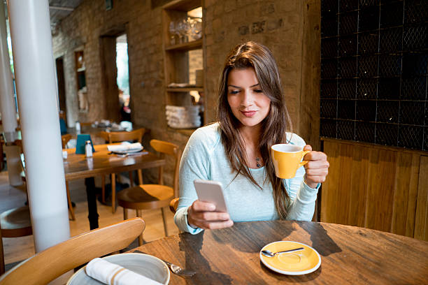 istock Woman on her phone at a cafe 525498634