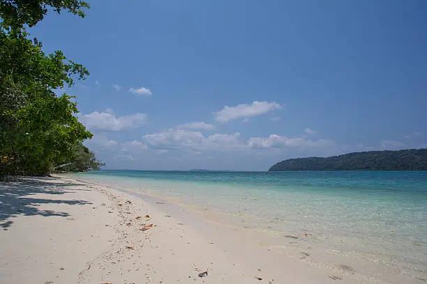 A mid-day picture of a gorgeous empty beach on a deserted island at the Andaman Islands, India.
