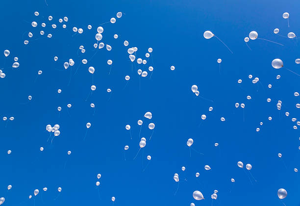 istock White balloons in the blue sky 525499915