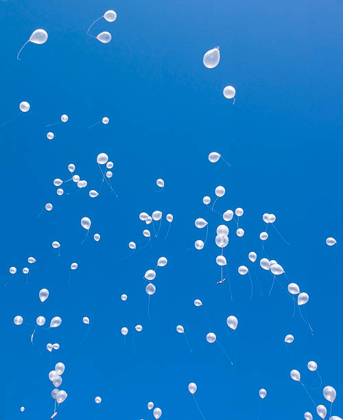 White balloons in the blue sky