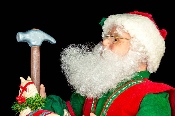 istock Christmas Sant with a toy hammer 525500433
