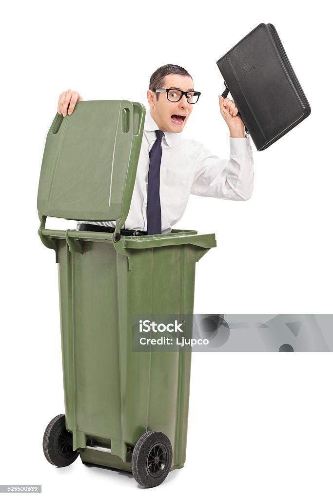 Terrified businessman hiding in a trash can Terrified businessman hiding in a trash can isolated on white background 20-29 Years Stock Photo