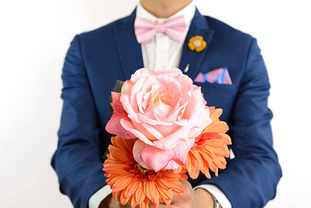 istock man in blue suit carry flowers 525500654