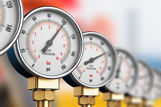 Row of industrial high pressure gas gauge meters stock photo