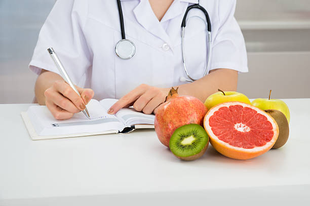 istock Female Dietician Writing Prescription 525501650