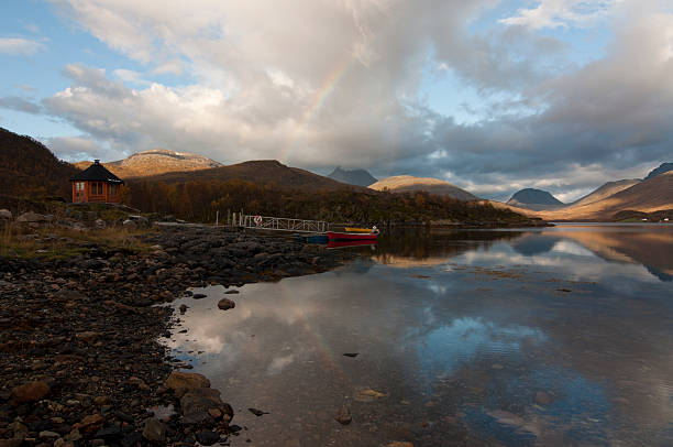istock Norway, Norwegian fjord, boat and rainbow 525501884