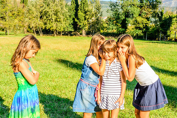 istock Four Little Girls Playing and Whispering Secrets 525509197