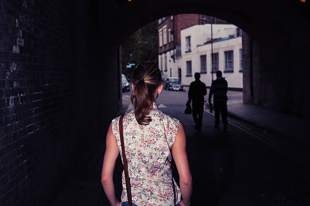 istock Young woman standing in tunnel 525510355