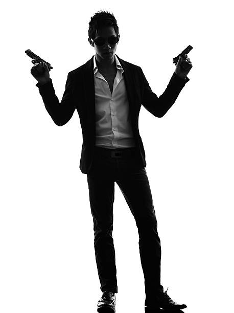 istock asian gunman killer standing   silhouette 525511433