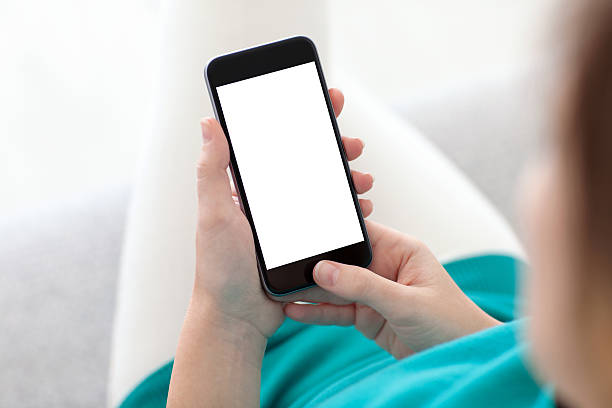istock woman holding a phone with isolated screen on a sofa 525512217