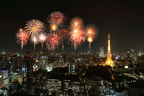 Fireworks celebrating over Tokyo cityscape at night, Japan