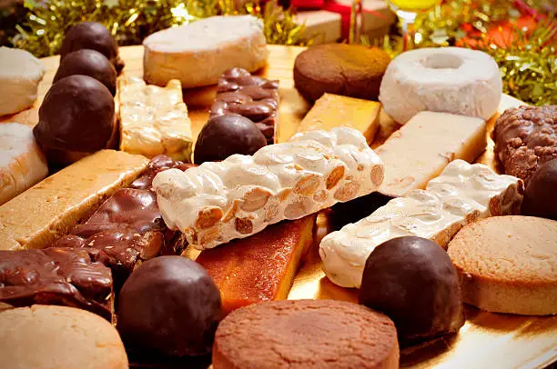 closeup of a tray with different turron, mantecados and polvorones, typical christmas sweets in Spain