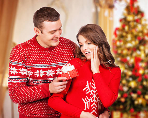 istock Lovely christmas couple holding presents 525514345