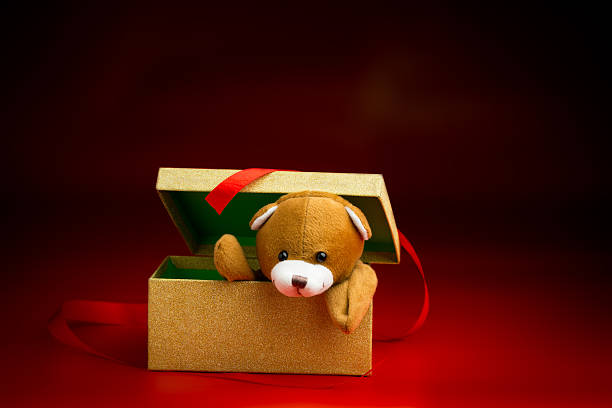 istock Christmas Teddy Popping Out of a Gift Box 525525293