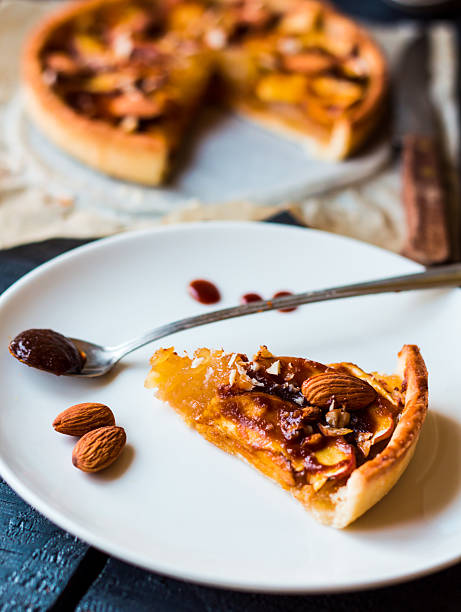 istock piece of apple tart on a white plate, spoon caramel 525525495