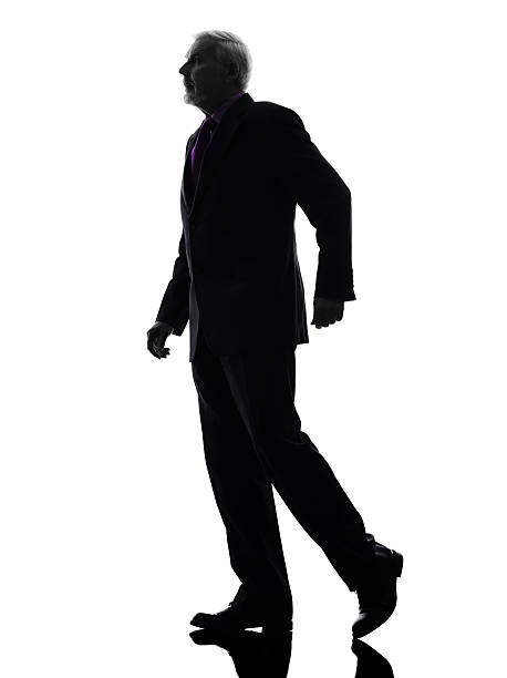istock senior business man walking silhouette 525525561
