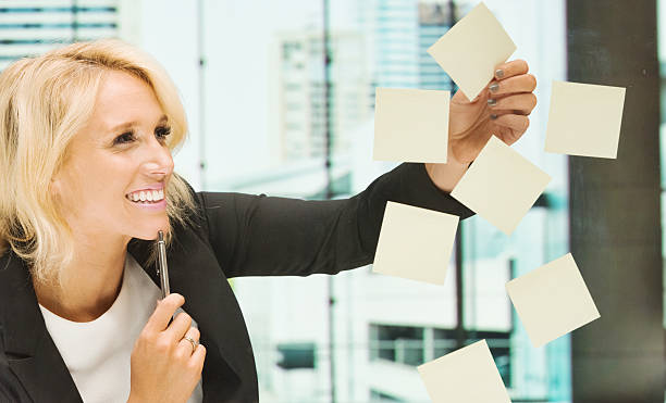 istock Businesswoman in the office looking at posit notes 525526873