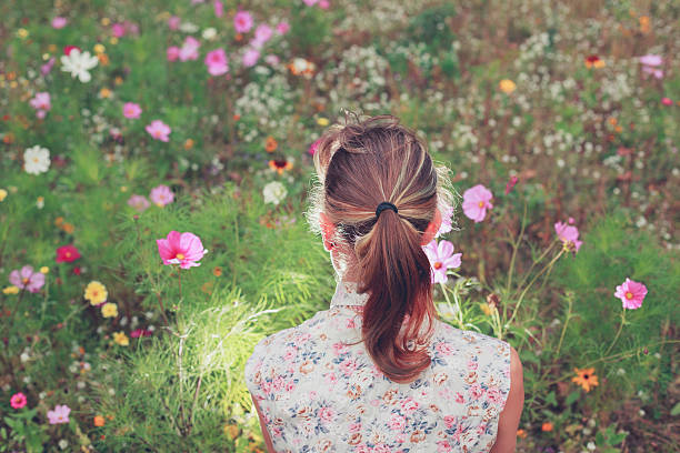 istock Young woman sitting in meadow 525529203