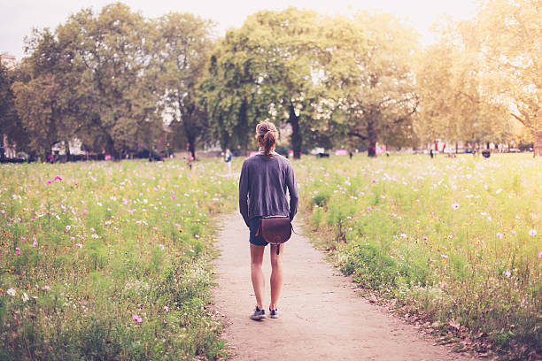 istock Young woman standing in meadow 525529207