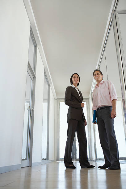 istock Business People Standing In Office Corridor 525530359