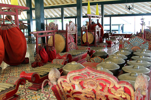 Yogyakarta, Indonesia - August 13, 2014: Musical instruments used for gamelan performances, including the Kulintang (gongs), Saron Barung (xylophone), and drums.