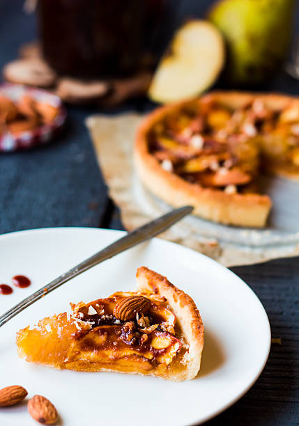 istock piece of apple tart on a white plate, spoon caramel 525541493