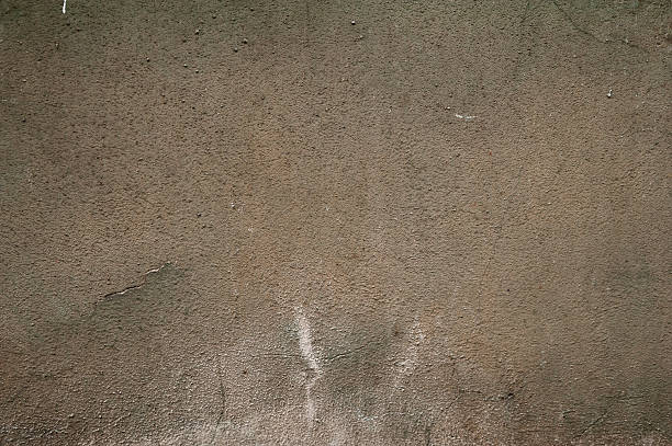 istock Texture of old wall covered with brown stucco 525541985