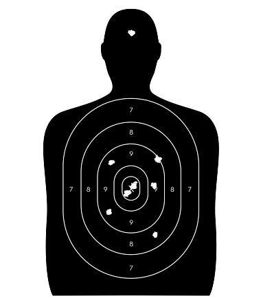 Gun firing range target shaped like a human, with bullet holes in the bull's-eye and a headshot. Isolated on a white background with clipping path.
