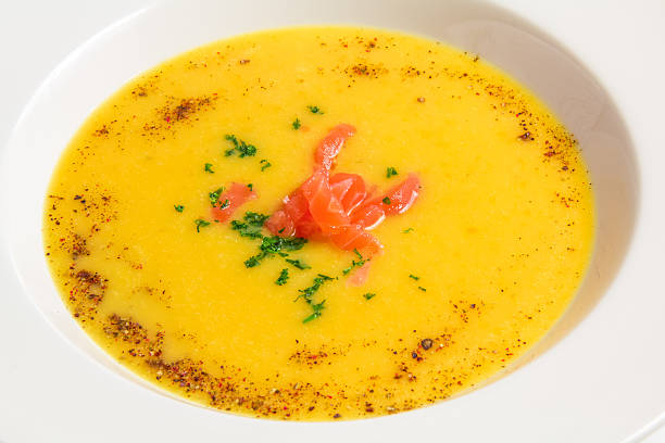istock Closeup orange soup in a white plate 525543079
