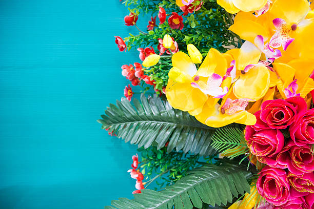istock yellow artificial orchid with green wall for background 525543841