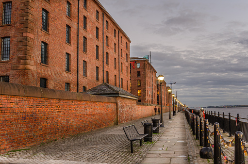 Cobbled footpath lined with renovated brick buildings at Liverpool's Waterfront at Twilight