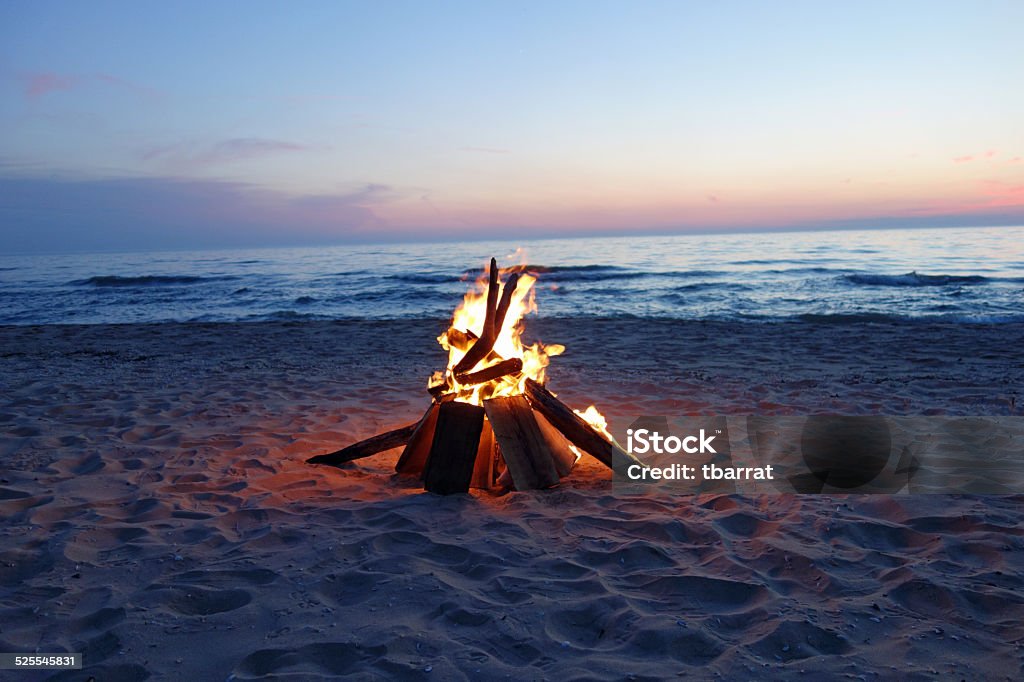 Beautiful campfire by the lake Beautiful campfire by the lake at dusk. Beach Stock Photo
