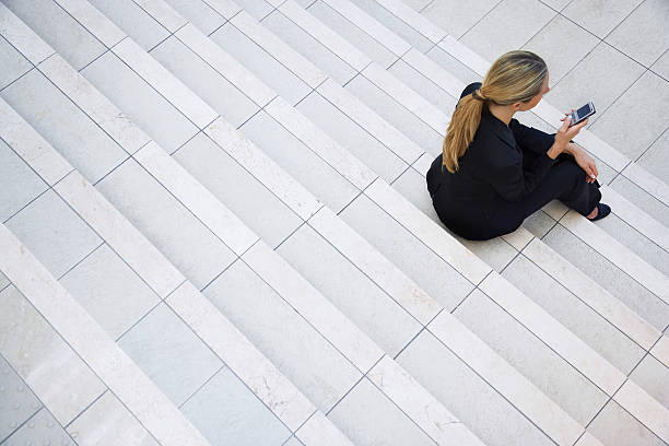 istock Businesswoman Sitting on Stairs 525546961