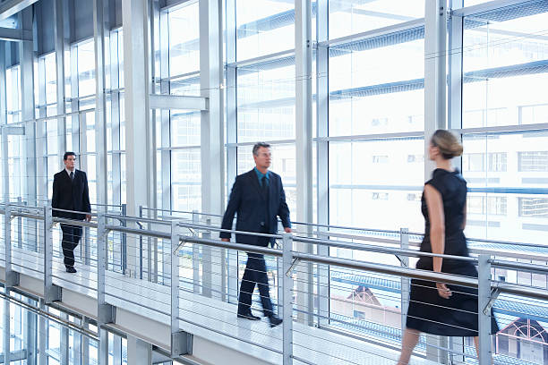 istock Business People Walking By Railing In Modern Office 525547015