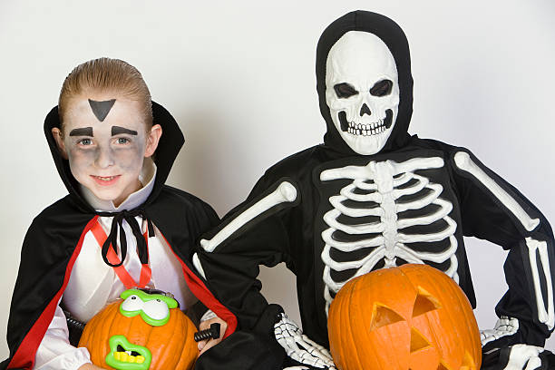 istock Boy's In Halloween Outfit With Pumpkins 525547017
