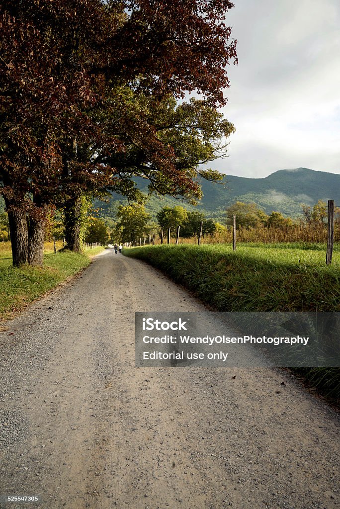 Cades Cove, Tennessee Townsend, Tennessee, USA. September 26, 2014. In the background are two people walking down a road in Cades Cove, Tennessee which is a part of the Great Smoky Mountains National Park. Appalachia Stock Photo