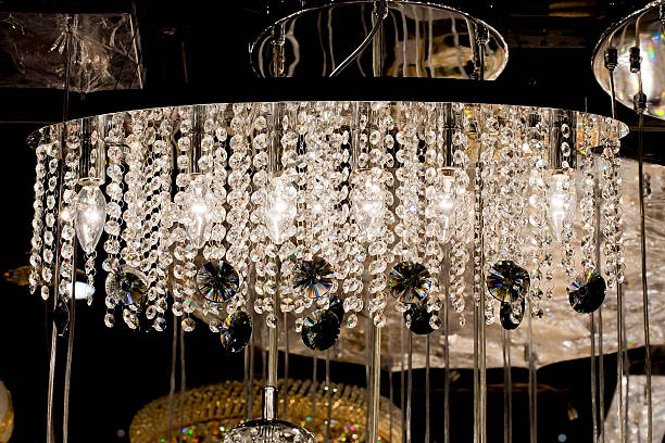 istock Contemporary glass chandelier isolated over black background 525547511
