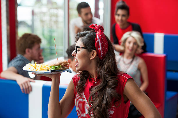 istock Girl with hamburger at the restaurant 525555841