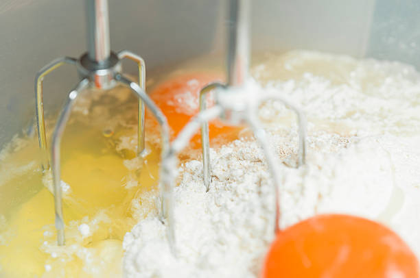 istock Mixing egg, flour and sugar cream in bowl 525555933