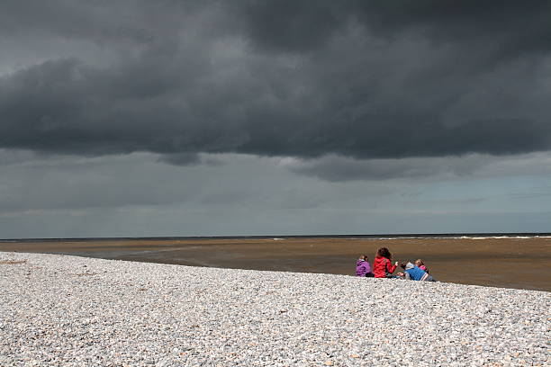 Le Hourdel, France - April 26, 2011: Le hourdel in somme bay,Picardy region of France. Family watching the stormy sea