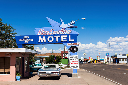 Tucumcari, United States - August 2, 2013: Old fashioned car parked in front of a motel along the historic route 66.