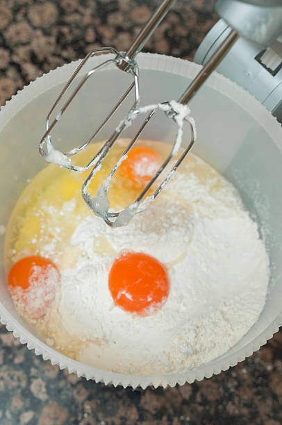 istock Mixing egg, flour and sugar cream in bowl 525558489