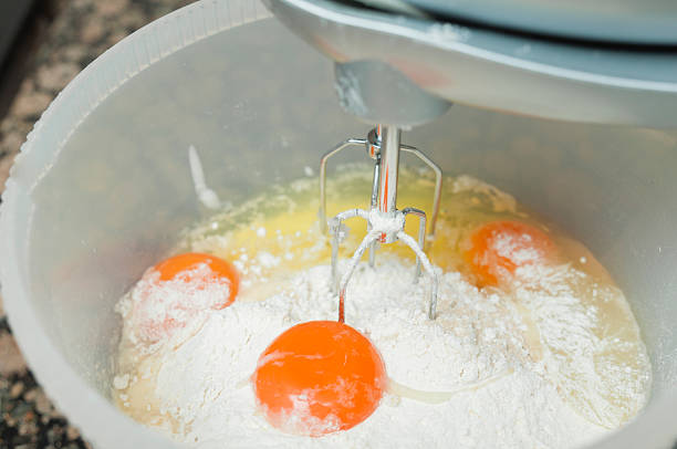 istock Mixing egg, flour and sugar cream in bowl 525558491