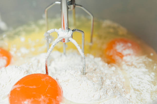 istock Mixing egg, flour and sugar cream in bowl 525558493