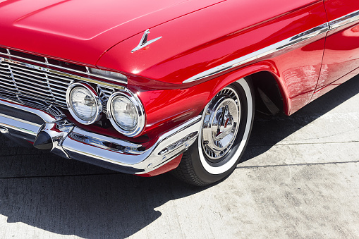 Close up of a vintage car parked outside on the street. 