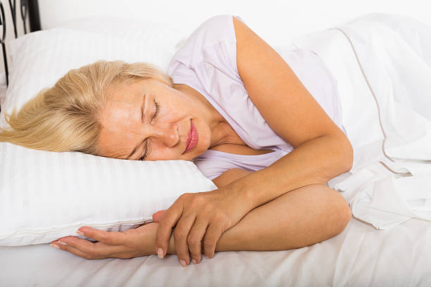 istock Middle-aged woman sleeping in bed 525558673