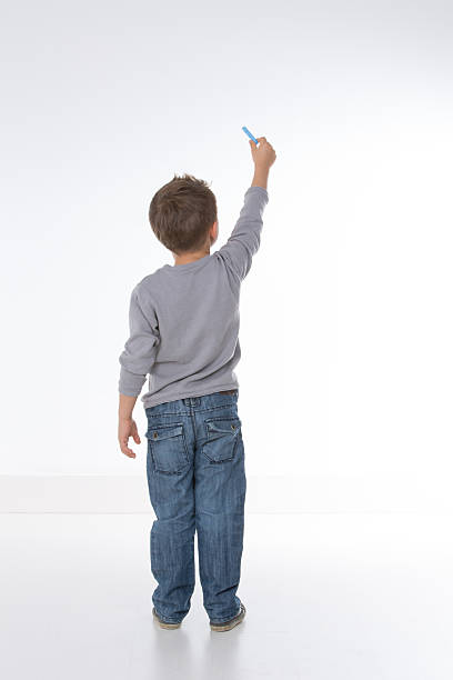 child shown from behind little kid about to draw something ass boy stock pictures, royalty-free photos & images