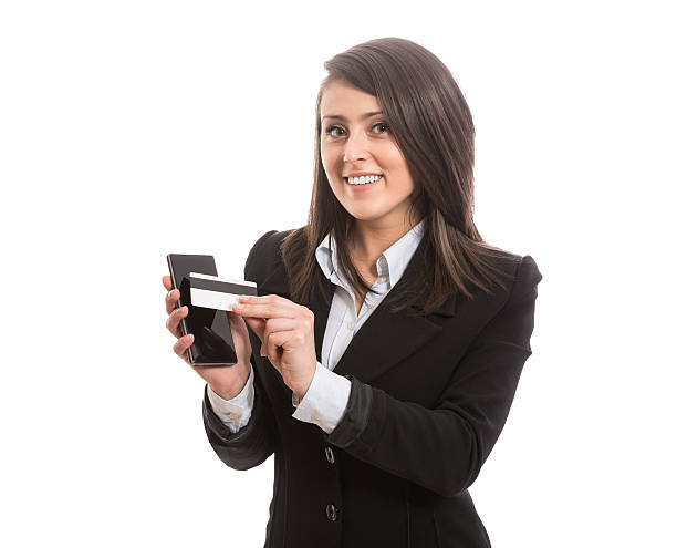 istock Smiling attractive elegant woman paying with smart phone 525562865