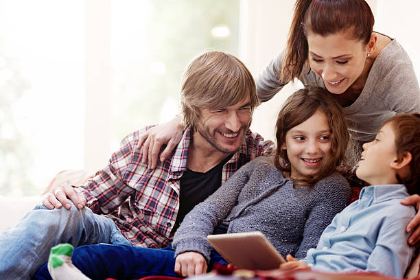 istock Family relaxing, playing with digital tablet 525563337