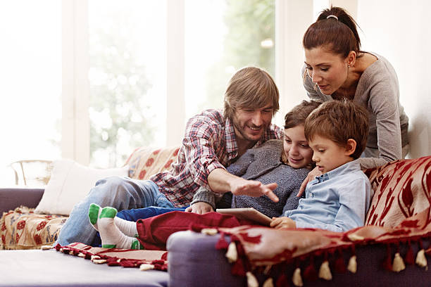 istock Family relaxing, playing with digital tablet 525563339